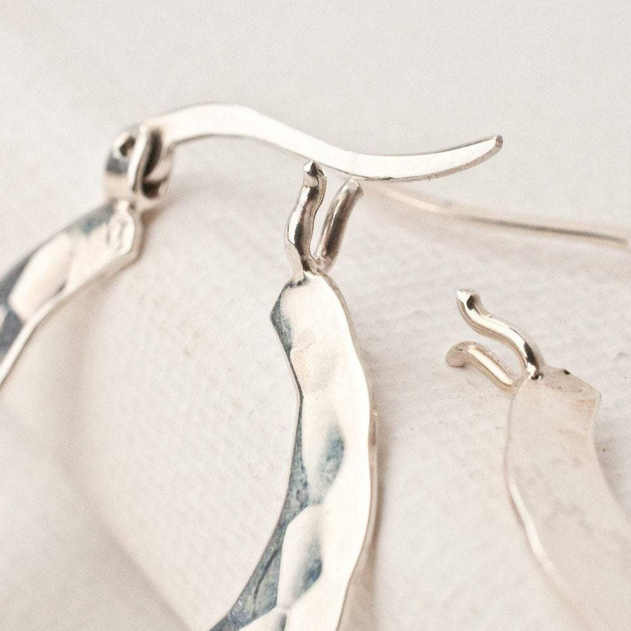 Silver textured and hammered earrings with french lock hinged closure.